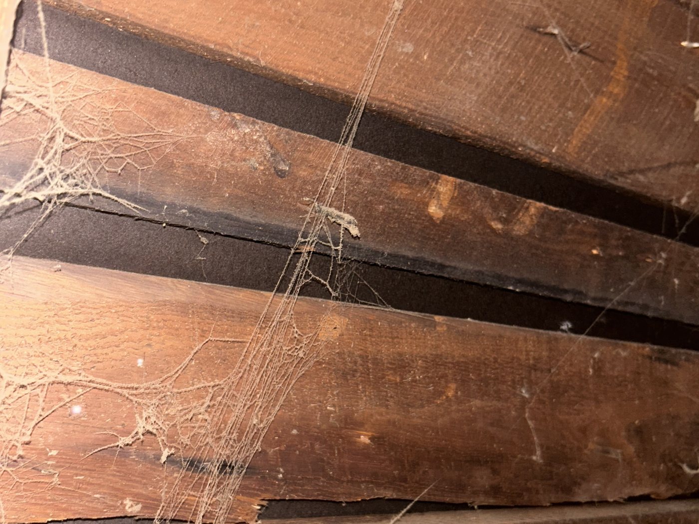 Close-up of gap board roof decking showing open gaps between adjacent planks